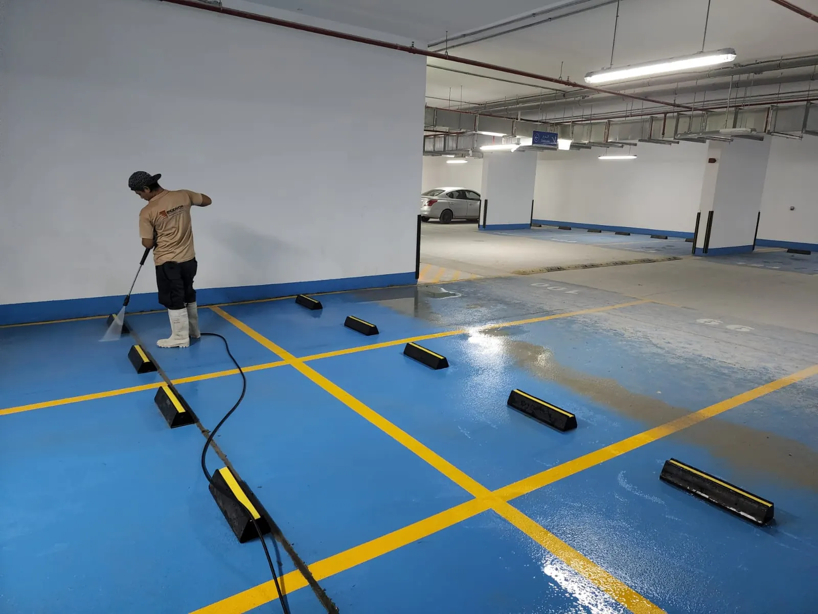 Endeavor technician pressure washing a residential car park in Dubai